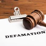 A gavel over documents on the subject of defamation
